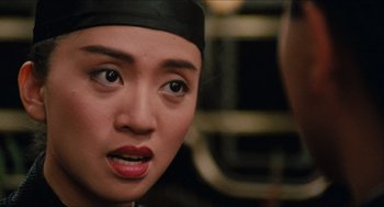 Movie still from “Rouge” (1987), directed by Stanley Kwan – A person wearing a black hat; Close Up shot, Over the shoulder angle