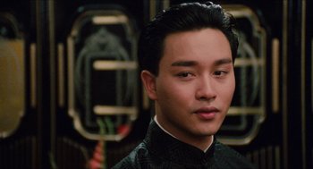 Movie still from “Rouge” (1987), directed by Stanley Kwan – A person wearing a suit and tie; Close Up shot, Over the shoulder angle