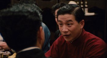 Movie still from “Rouge” (1987), directed by Stanley Kwan – A group of people that are talking to each other; Close Up shot, Over the shoulder angle