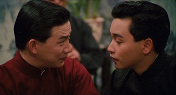 Movie still from “Rouge” (1987), directed by Stanley Kwan – Two asian men talking to each other in a room; Close Up shot, Over the shoulder angle