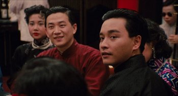 Movie still from “Rouge” (1987), directed by Stanley Kwan – Two men sitting next to each other in a room; Close Up shot, Over the shoulder angle