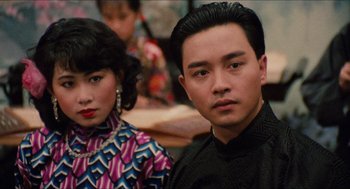 Movie still from “Rouge” (1987), directed by Stanley Kwan – A man and a woman are posing for a picture; Close Up shot, Over the shoulder angle