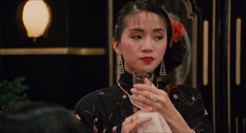 Movie still from “Rouge” (1987), directed by Stanley Kwan – A woman holding a wine glass in her hand; Close Up shot, Over the shoulder angle