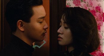 Movie still from “Rouge” (1987), directed by Stanley Kwan – A man and a woman face to face in front of a wall; Close Up shot, Low angle