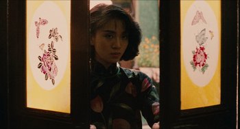 Movie still from “Rouge” (1987), directed by Stanley Kwan – A woman standing in front of an open window; Medium shot, Over the shoulder angle