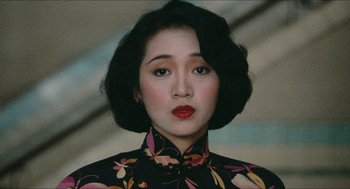 Movie still from “Rouge” (1987), directed by Stanley Kwan – A person with short hair wearing a dress; Close Up shot, High angle