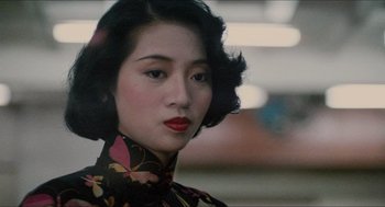 Movie still from “Rouge” (1987), directed by Stanley Kwan – A woman in a black and red dress with red lipstick; Close Up shot, Over the shoulder angle