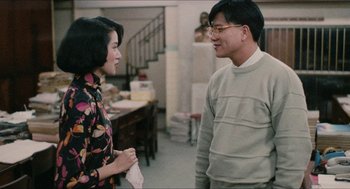 Movie still from “Rouge” (1987), directed by Stanley Kwan – A man and a woman talking to each other; Medium shot, Over the shoulder angle