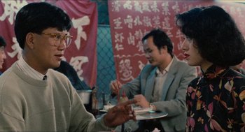 Movie still from “Rouge” (1987), directed by Stanley Kwan – A group of people sitting around a table; Medium shot, Over the shoulder angle