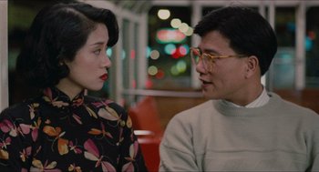 Movie still from “Rouge” (1987), directed by Stanley Kwan – A man and a woman sitting next to each other; Medium shot, Over the shoulder angle