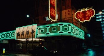 Movie still from “Rouge” (1987), directed by Stanley Kwan – A neon sign lit up at night on a building; Extreme Wide shot, High angle