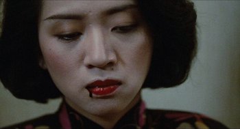 Movie still from “Rouge” (1987), directed by Stanley Kwan – A person with red lipstick on her mouth; Close Up shot, Over the shoulder angle