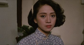 Movie still from “Rouge” (1987), directed by Stanley Kwan – A young woman with dark hair wearing a cheongsam; Close Up shot, Over the shoulder angle