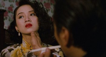 Movie still from “Rouge” (1987), directed by Stanley Kwan – A woman with red lipstick looking into a mirror while another woman holds a toothbrush; Close Up shot, Over the shoulder angle