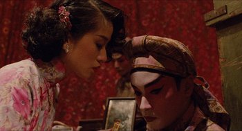 Movie still from “Rouge” (1987), directed by Stanley Kwan – A man and a woman looking at each other in front of a mirror; Close Up shot, Over the shoulder angle