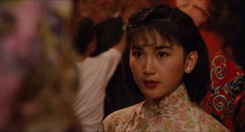 Movie still from “Rouge” (1987), directed by Stanley Kwan – A young woman in a floral dress is looking at the camera; Close Up shot, Over the shoulder angle
