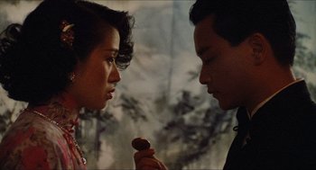 Movie still from “Rouge” (1987), directed by Stanley Kwan – A man and a woman looking at each other; Close Up shot, Over the shoulder angle