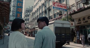 Movie still from “Rouge” (1987), directed by Stanley Kwan – A man and a woman standing on the side of the street; Wide shot, Low angle