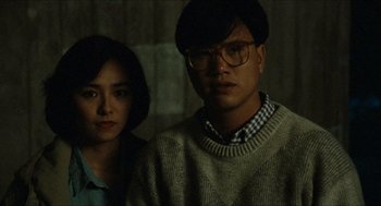 Movie still from “Rouge” (1987), directed by Stanley Kwan – A man and a woman standing next to each other; Close Up shot, Low angle