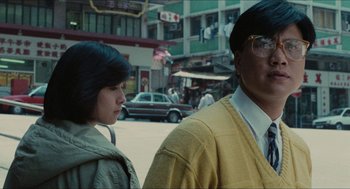 Movie still from “Rouge” (1987), directed by Stanley Kwan – A man and a woman standing next to each other on the street; Medium shot, Over the shoulder angle