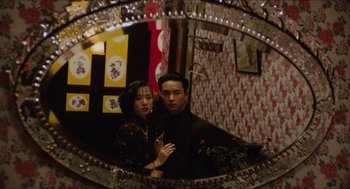 Movie still from “Rouge” (1987), directed by Stanley Kwan – A man and a woman standing in front of a mirror; Medium shot, Low angle