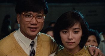 Movie still from “Rouge” (1987), directed by Stanley Kwan – A man and a woman standing next to each other; Close Up shot, Low angle