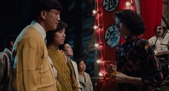 Movie still from “Rouge” (1987), directed by Stanley Kwan – A group of people standing in front of a building; Medium shot, Over the shoulder angle