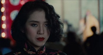 Movie still from “Rouge” (1987), directed by Stanley Kwan – A person wearing a black and red shirt; Close Up shot, Over the shoulder angle