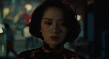 Movie still from “Rouge” (1987), directed by Stanley Kwan – A person with short hair wearing a dress; Close Up shot, Over the shoulder angle