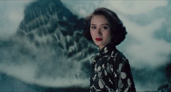 Movie still from “Rouge” (1987), directed by Stanley Kwan – A woman in a black and white floral dress; Medium shot, High angle