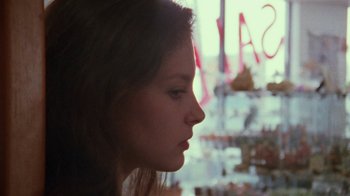 Movie still from “Ruby in Paradise” (1993), directed by Victor Nunez – A woman looking out of a window at a store window; Close Up shot, Over the shoulder angle