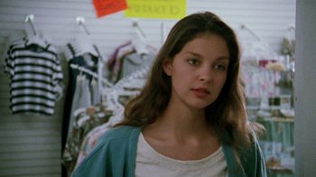 Movie still from “Ruby in Paradise” (1993), directed by Victor Nunez – A young woman standing in front of clothes; Close Up shot, Over the shoulder angle