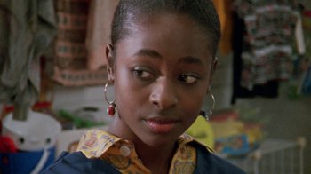 Movie still from “Ruby in Paradise” (1993), directed by Victor Nunez – A young woman wearing a yellow and blue shirt; Close Up shot, Over the shoulder angle