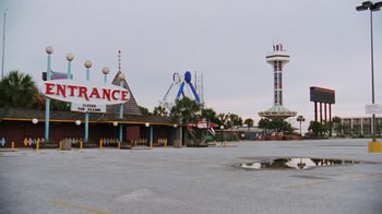 Movie still from “Ruby in Paradise” (1993), directed by Victor Nunez – A view of an amusement park from the parking lot; Extreme Wide shot, High angle