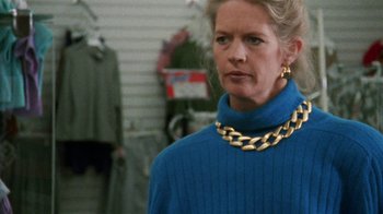 Movie still from “Ruby in Paradise” (1993), directed by Victor Nunez – A woman wearing a blue sweater and a gold chain necklace; Close Up shot, Low angle
