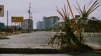 Movie still from “Ruby in Paradise” (1993), directed by Victor Nunez – A view of a city street with tall buildings in the background; Extreme Wide shot, Low angle