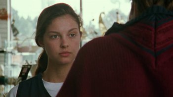 Movie still from “Ruby in Paradise” (1993), directed by Victor Nunez – A young girl is looking at the camera; Close Up shot, Over the shoulder angle