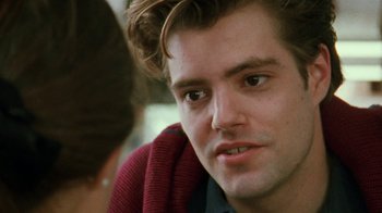 Movie still from “Ruby in Paradise” (1993), directed by Victor Nunez – A person wearing a sweater; Close Up shot, Over the shoulder angle