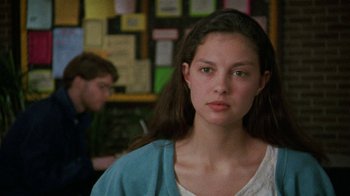 Movie still from “Ruby in Paradise” (1993), directed by Victor Nunez – A young woman with long dark brown hair and green eyes; Close Up shot, Over the shoulder angle
