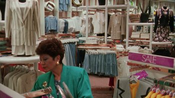 Movie still from “Ruby in Paradise” (1993), directed by Victor Nunez – A woman in a green jacket in front of a store; Medium shot, Over the shoulder angle