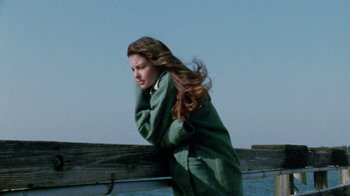 Movie still from “Ruby in Paradise” (1993), directed by Victor Nunez – A woman standing next to a wooden fence; Medium shot, Over the shoulder angle