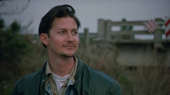 Movie still from “Ruby in Paradise” (1993), directed by Victor Nunez – A man in a green jacket looking to his left; Close Up shot, Low angle