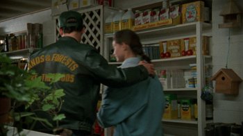 Movie still from “Ruby in Paradise” (1993), directed by Victor Nunez – A man and a woman are standing in front of a shelf; Medium shot, Over the shoulder angle