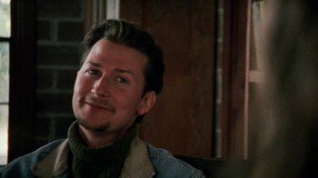 Movie still from “Ruby in Paradise” (1993), directed by Victor Nunez – A person sitting on a couch; Close Up shot, Over the shoulder angle