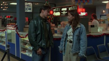 Movie still from “Ruby in Paradise” (1993), directed by Victor Nunez – A man and a woman standing next to each other in a restaurant; Medium shot, Over the shoulder angle