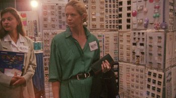 Movie still from “Ruby in Paradise” (1993), directed by Victor Nunez – A woman in a green dress is holding a purse; Medium shot, Low angle