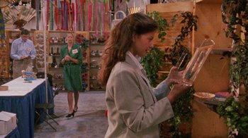 Movie still from “Ruby in Paradise” (1993), directed by Victor Nunez – A woman is looking at an item in a store; Medium shot, Low angle