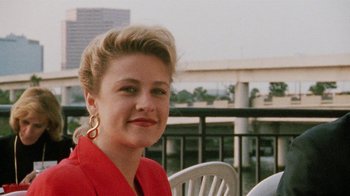 Movie still from “Ruby in Paradise” (1993), directed by Victor Nunez – A woman in a red jacket sitting on top of a white chair; Close Up shot, Low angle