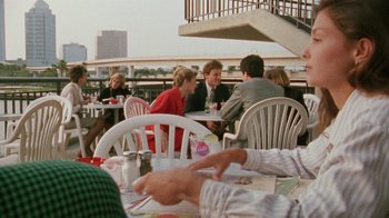 Movie still from “Ruby in Paradise” (1993), directed by Victor Nunez – A group of people sitting at a table with plates of food on it; Medium shot, Over the shoulder angle