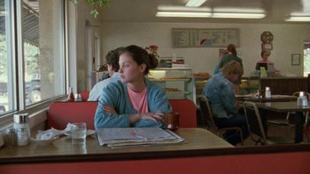 Movie still from “Ruby in Paradise” (1993), directed by Victor Nunez – A woman sitting at a table in a restaurant; Medium shot, Over the shoulder angle